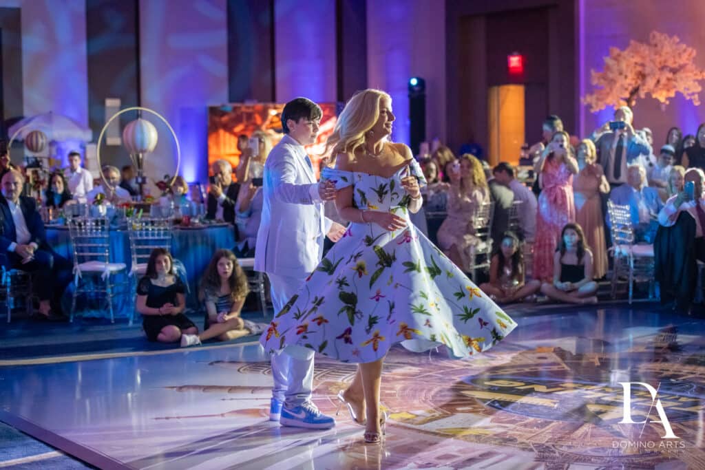 Mother and son dance at an aviation-inspired Around the World Bar Mitzvah celebration.